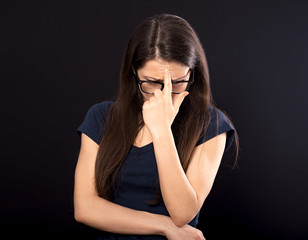 Unhappy worried woman in glasses holding the hand under the face and find the solution on problem situation. Corona virus. Studio portrait