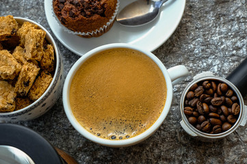 Coffee cup on wooden rustic background. Top view with morning sunlight