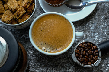 Coffee cup on wooden rustic background. Top view with morning sunlight