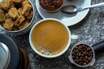 Coffee cup on wooden rustic background. Top view with morning sunlight