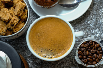 Coffee cup on rock kitchen table. Top view with morning sunlight