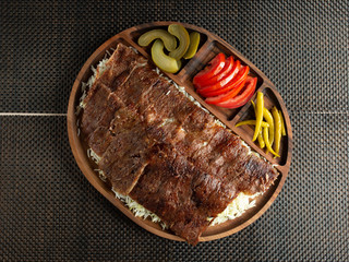 steak slices serve on rice with tomato slices pickled cucumbers and peppers