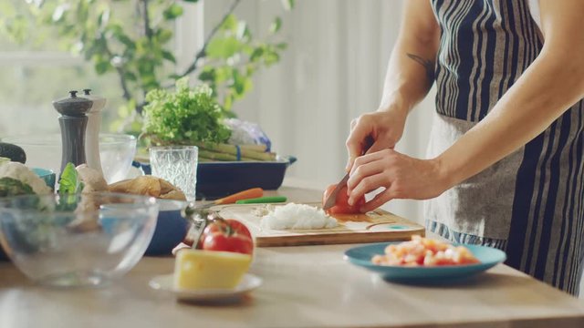 Close Up Footage of a Man Chopping a Tomato with a Sharp Kitchen Knife