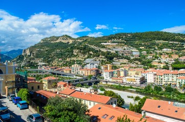 Fototapeta premium Ventimiglia town, Italy. View on the city, mountains with blue sky, italian riviera. Border with France, Cote de Azur