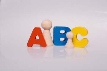 ABC and Wooden figurines of people as family concept