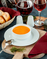 a bowl of lentil soup served with wine and bread