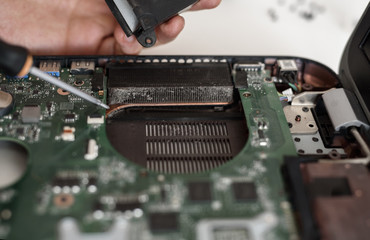 Fixing laptop. Disassembling a notebook and cleaning its cooling system. Dust and dirt on computer...