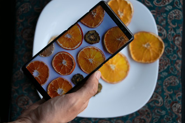 Taking photos of the plate full of dried fruits