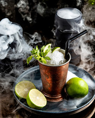 a copper glass with mojito cocktail with ice shavings