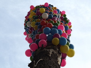 Down view of a decorated tree with colorful balloons