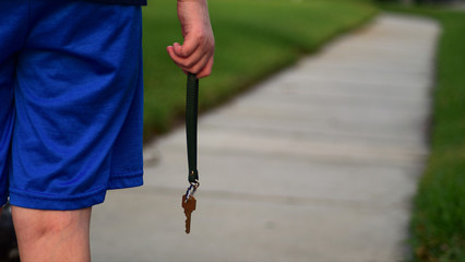 Close-up photo of a young Child who is holding the house key symbolizing children are our future