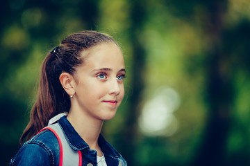 Portrait of a smiling schoolgirl with backpack
