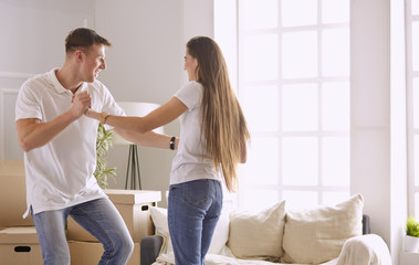 Lovely couple dancing in new empty flat