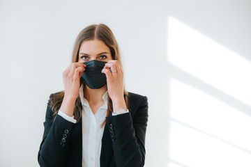 successful business woman putting on a breathing mask