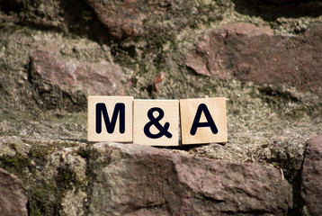 Close-up Of King Chess Pieces On Wooden Blocks With Mergers And Acquisitions