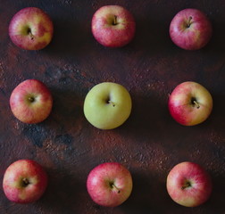 Red and green apples forming a square .