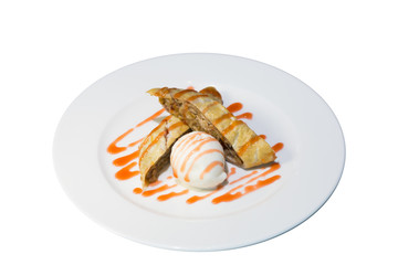 dessert dish with Apple strudel and ice cream, poured with fruit jam