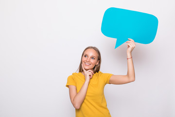 Young beautiful girl holding a green bubble for text, isolated on a white background