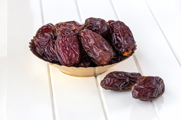 Organic dried dates in traditional arabic golden plate. Holy month Ramadan concept. Top view.