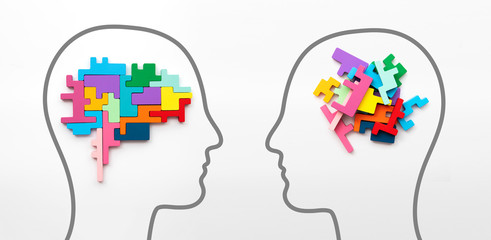 Right and left sides of the brain concept. Puzzle pieces in the shape of a brain