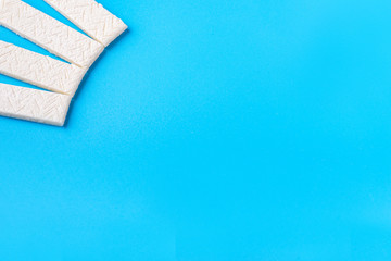 Chewing gum on a blue background that can be used for lettering. Chewing gum in a wrapper