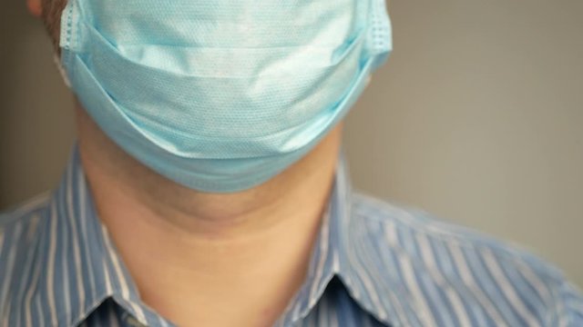 a sad man with virus, covid-19 and mask on his face for antivirus protection taking deep breath, rapid breathing