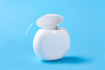Dental floss on a blue background. Free space for text