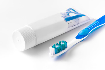 Toothbrush and dental floss on a white background. The view from the top.