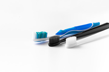 A set of multi-colored toothbrushes on a white background. Place to write the text.