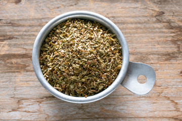 Dried Oregano in  Measuring Cup