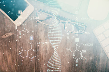 Double exposure of DNA drawing over table with phone. Top view. Science education concept.