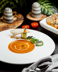 a plate of lentil soup garnished with cream