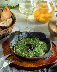 azerbaijani kookoo egg dish with herbs served in iron pan