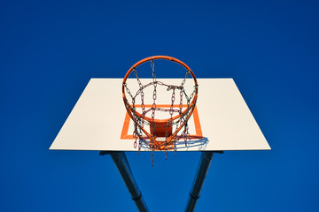 basketball hoop and net against blue sky on sunny day