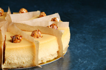 caramel cheesecake with popcorn and salted caramel sauce on blue marble background. portioned dessert decoreted popcorn