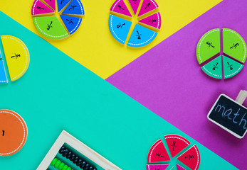Colorful fractions in mathematics on the green, yellow, purple background. Interesting, fun math...