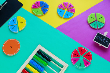 Colorful fractions in mathematics on the green, yellow, purple background. Interesting, fun math...