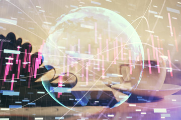 Double exposure of financial chart drawing and desktop with coffee and items on table background. Concept of forex market trading