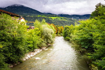 Brixen Bressanone rver stream autumn colors forest, Italy.