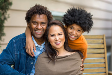 Portrait of a mixed race family smiling.