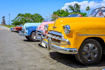 Havana Cuba Yellow collaection vintage classic american car in a typical with sunny blue sky 