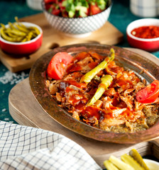 close up of chicken doner kebab served with tomato sauce aubergine salad and pickles