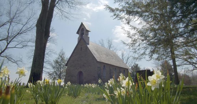 Push through spring flowers to rural church