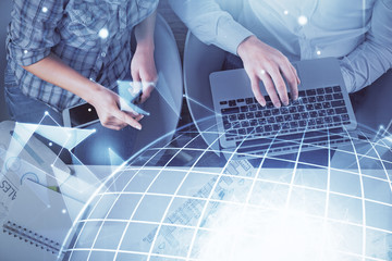 Double exposure of man and woman working together and world map hologram drawing. international network concept. Computer background. Top View.