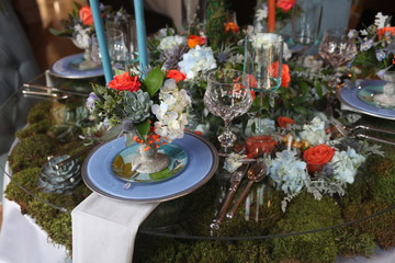 table setting, blue plate, glass vine, orange rose, blue candle
