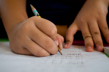 closeup hand writing paper, education concept
