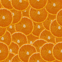 Seamless pattern: orange slices. Wallpaper with a pattern of slices of juicy orange.