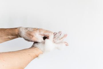 a man hands between fingers wash his hands with soap bubble cleaning hands wash off germs virus plain white background