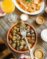 close up view of grape leaves dolma on a fork