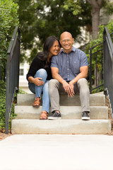 Fototapeta na wymiar Happy Asian couple smiling and hugging outside.
